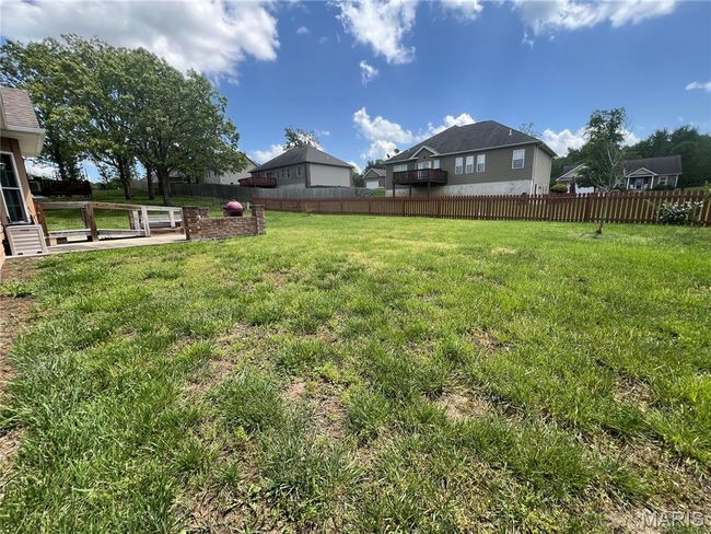 View of fenced backyard | Image 25