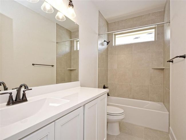Bathroom with vanity, tile patterned flooring, and bathing tub / shower combination | Image 14