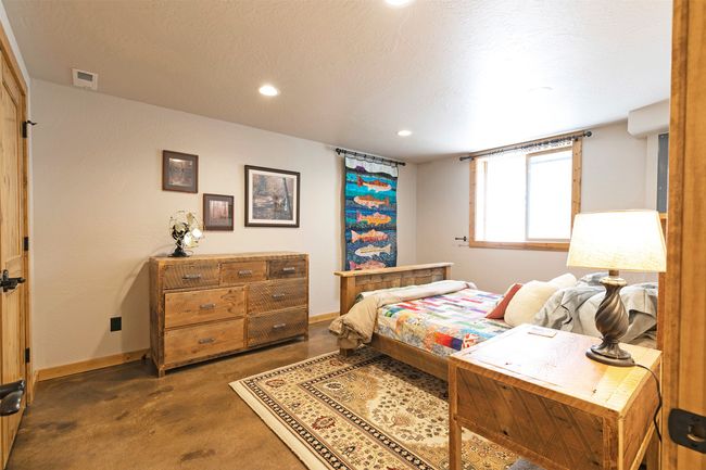 Bedroom with baseboards, recessed lighting, and concrete flooring | Image 35