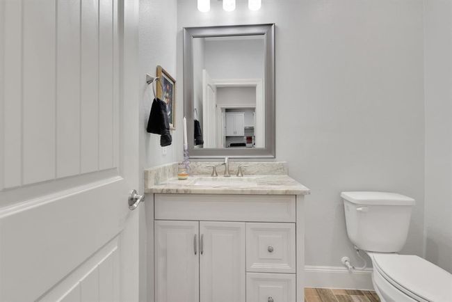 A conveniently located half bath sits just off the oversized garage—perfect for guests or quick clean-ups after a busy day. | Image 34