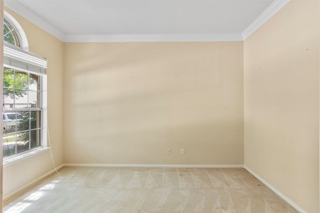 Empty room with light carpet, ornamental molding, and baseboards | Image 7