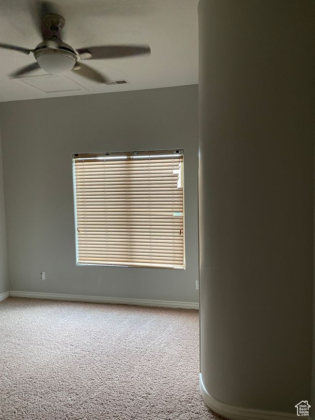 Carpeted empty room featuring a ceiling fan and baseboards | Image 20