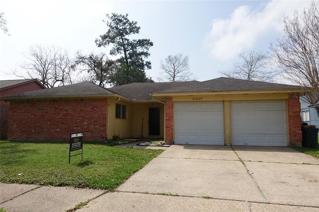 Charming curb appeal with a spacious driveway and a two-car garage, nestled in a tranquil neighborhood setting. Perfect for those seeking a welcoming home atmosphere. | Image 22