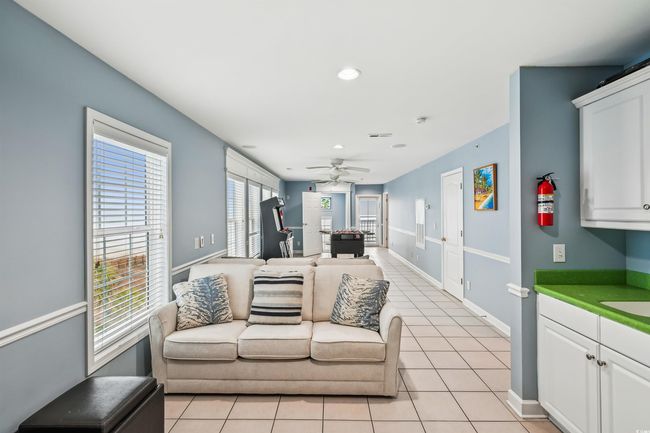 Living room featuring light tile patterned flooring, recessed lighting, and a ceiling fan | Image 20