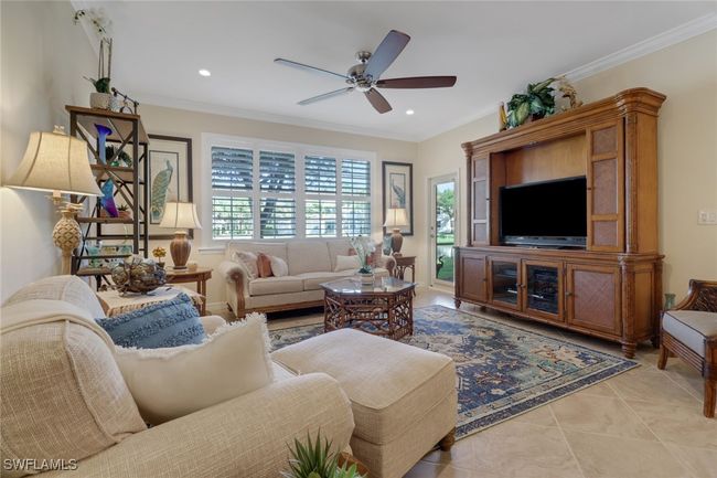 Living room with a ceiling fan, plenty of natural light, crown molding, and recessed lighting | Image 5