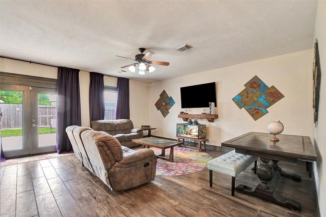 This family room flows to the kitchen. | Image 11