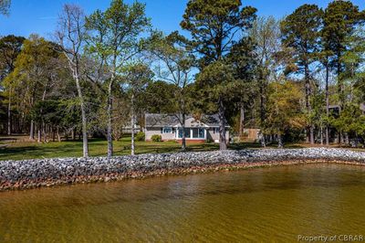 Dock area featuring a water view and a lawn | Image 1