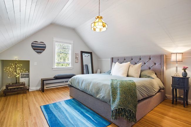 Bedroom with baseboards, lofted ceiling, and wood finished floors | Image 17