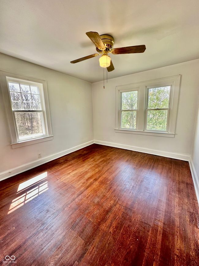 spare room featuring baseboards, a ceiling fan, and wood finished floors | Image 35