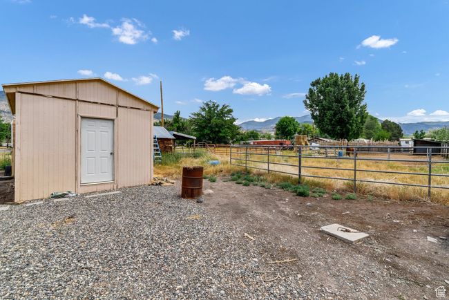 View of yard with a mountain view and an outbuilding | Image 24