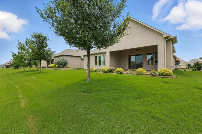 Rear view of house showing a lawn, and stucco siding | Image 31