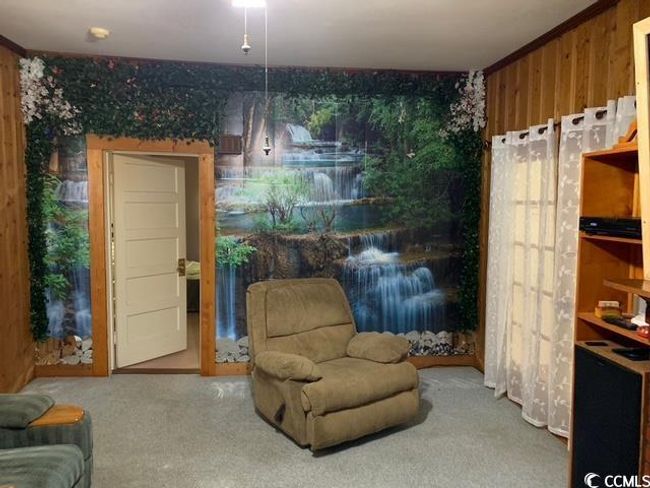 Sitting room featuring wood walls and carpet flooring | Image 17