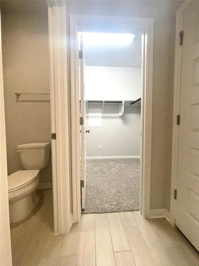 Bathroom with toilet and wood finished floors | Image 12