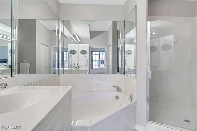 Full bathroom with a shower stall, a garden tub, and vanity | Image 9