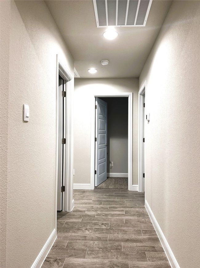 Hallway featuring wood finished floors and a textured​​‌​​​​‌​​‌‌​‌‌​​​‌‌​​‌‌​‌​​​​​‌ wall | Image 14