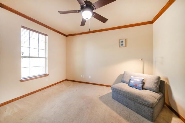 Sitting room featuring ornamental molding, healthy amount of natural light, carpet, and ceiling fan | Image 5