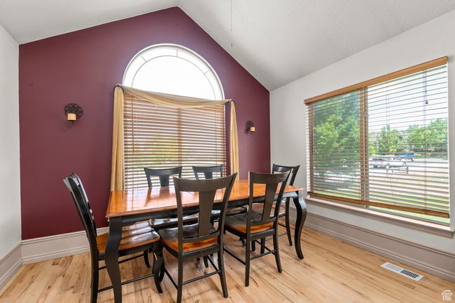 Dining area with lofted ceiling, light wood flooring, and baseboards | Image 9
