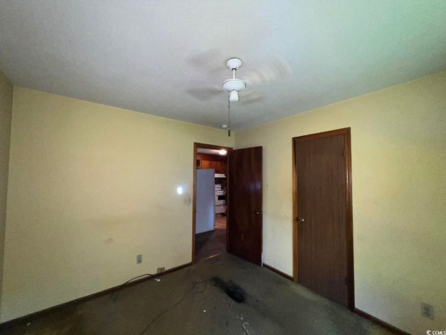 Unfurnished bedroom featuring baseboards, a ceiling fan, carpet, and a closet | Image 13