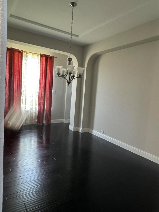Spare room with a chandelier and dark wood-style floors | Image 26