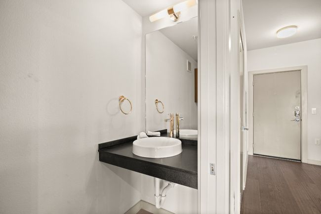 Bathroom featuring a sink and wood finished floors | Image 29