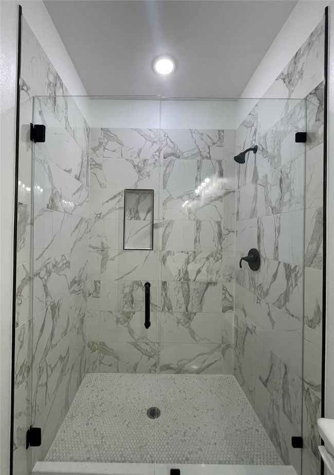 Full bathroom with a marble finish shower and toilet | Image 27