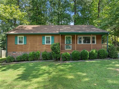 Single story home featuring a front lawn and covered front porch | Image 1