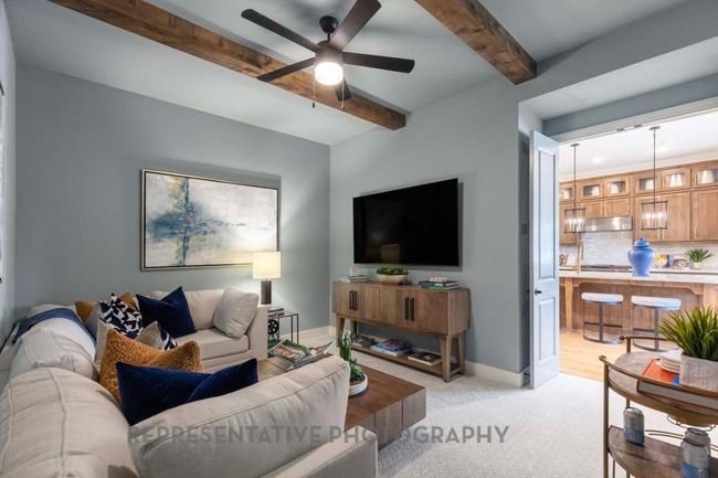 Living area featuring beam ceiling, ceiling fan, and light colored carpet | Image 36