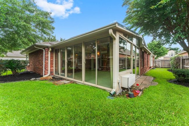 Beautifully maintained backyard offers a lush lawn, mature trees, and well-designed landscaping that enhances the outdoor ambiance. It’s an ideal space for enjoying quiet mornings, weekend gardening, or evening gatherings. | Image 36