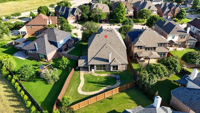 Rear view of house featuring a fenced backyard, a chimney, brick siding, and a patio | Image 36