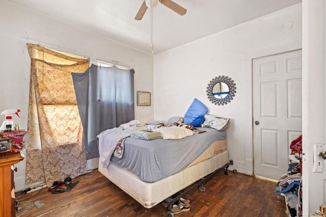 Bedroom featuring hardwood / wood-style flooring and a ceiling fan | Image 13