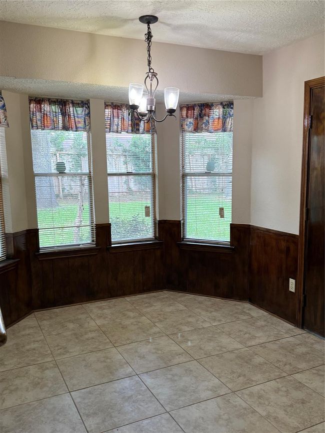 Dining room with a nice mirrored wall for that extra-large appearance. | Image 35