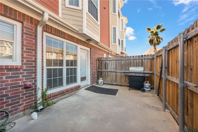 A private fenced patio has a gate leading directly to the community resort style pool! A premium location with no back neighbor! | Image 16