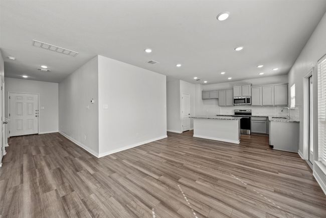 Unfurnished living room featuring wood-look tile floors and recessed lighting | Image 9