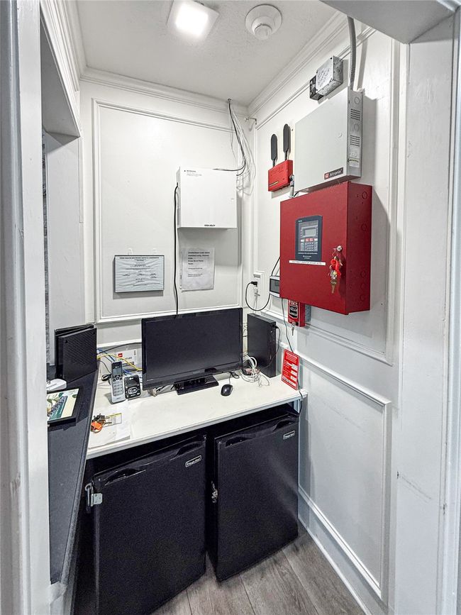 Office featuring light wood finished floors and ornamental molding | Image 7