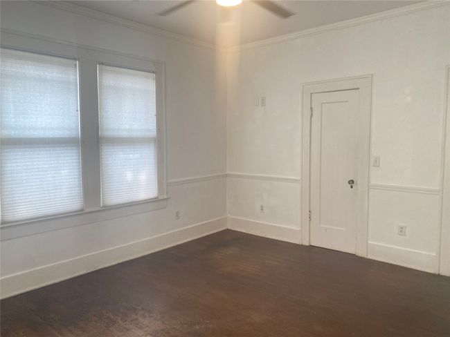 Unfurnished 2nd room featuring a ceiling fan, dark wood finished floors, and ornamental molding | Image 9