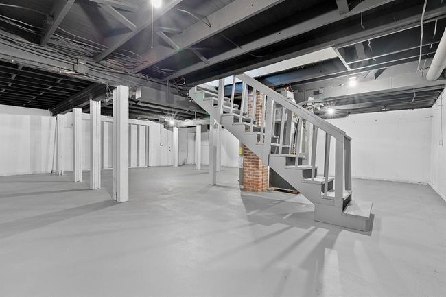 Unfinished basement featuring stairs | Image 22