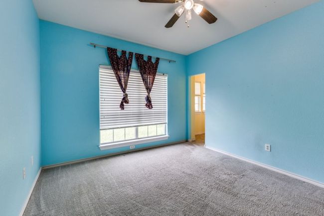 Carpeted spare room featuring ceiling fan, a wealth of natural light, and baseboards | Image 30