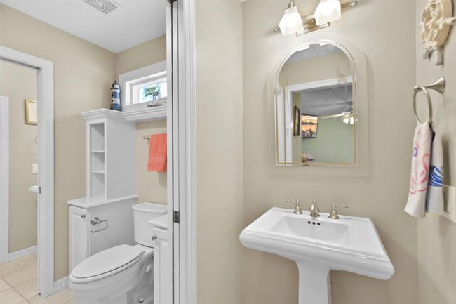 Experience convenience with the Jack-and-Jill bathroom, featuring elegant pedestal sinks and ample linen storage. | Image 34