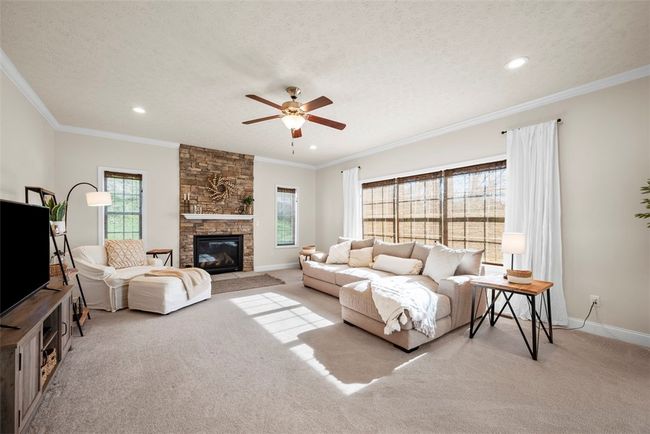 Gather with the family in this oversized family room that has an abundance of window to filter in lots of natural daylight. | Image 15