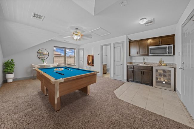 Recreation room with light colored carpet, pool table, indoor wet bar, and visible vents | Image 21