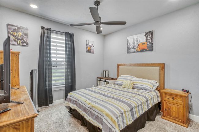 Carpeted bedroom with ceiling fan | Image 28