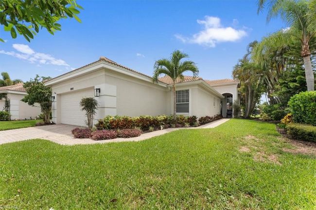 View of front of home with stucco siding, a tile roof, a front yard, and driveway | Image 4