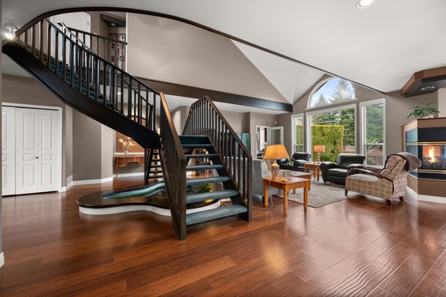 Stairs featuring high vaulted ceiling, baseboards, and wood finished floors | Image 17