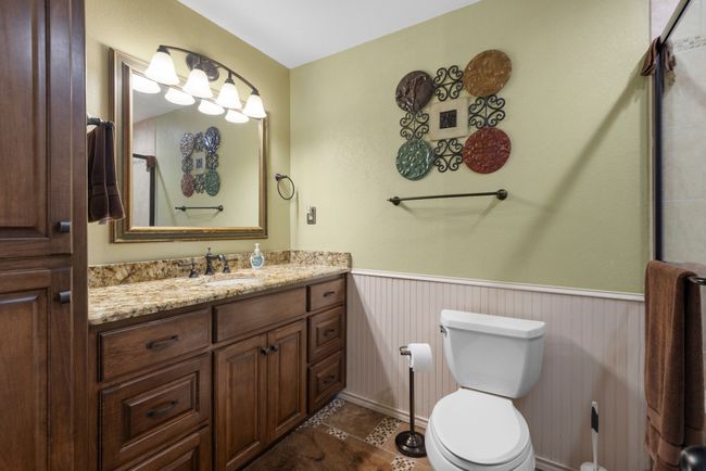 Full bath featuring a wainscoted wall, vanity, tile patterned floors, and a shower | Image 19