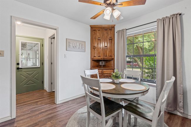 Dining space featuring wood finished floors and a ceiling fan | Image 9