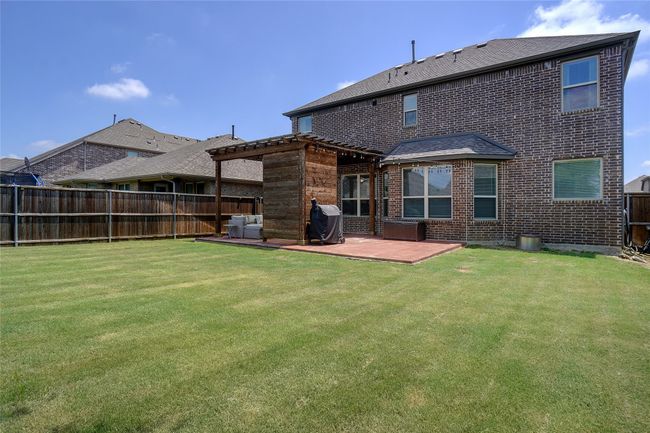 Back of house with brick siding, a patio area, and roof with shingles | Image 24