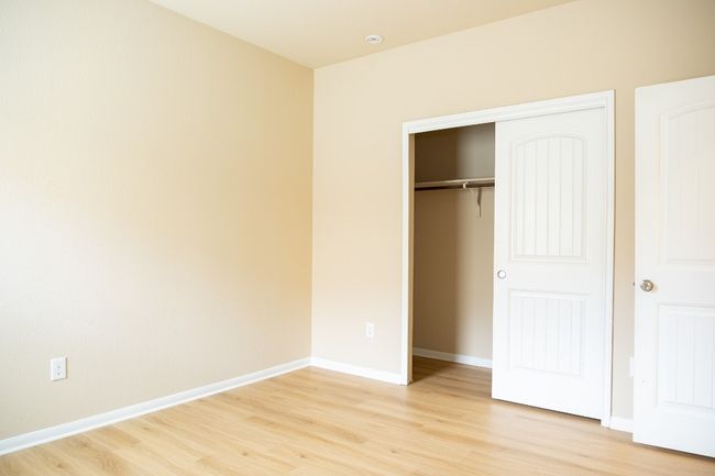 Unfurnished bedroom featuring light wood-style flooring, a closet, and baseboards | Image 19