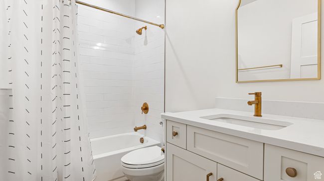 Full bath featuring shower / bath combo, vanity, and toilet | Image 65