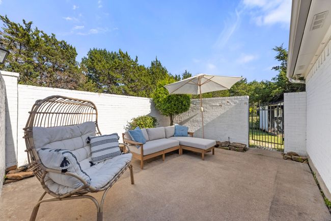 Fenced backyard with an outdoor living space and a patio area | Image 34