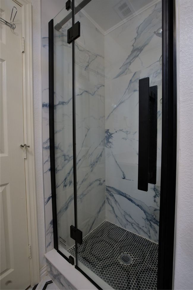 Full bath featuring a marble finish shower | Image 23